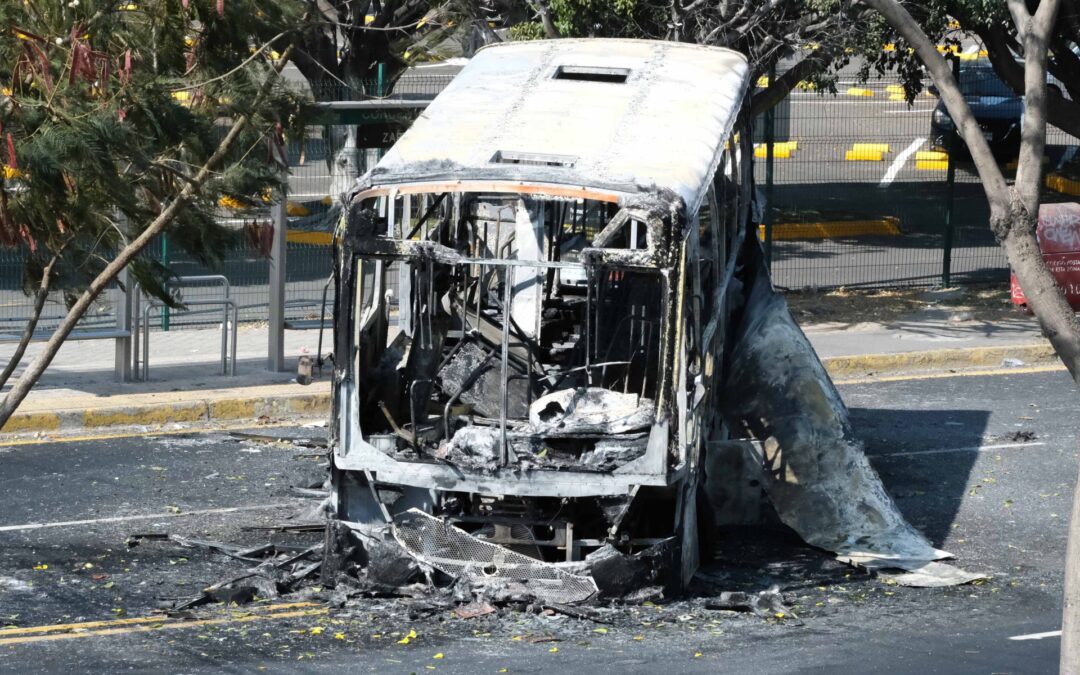 Burnt vehicles line highway near Mexican World Cup stadium