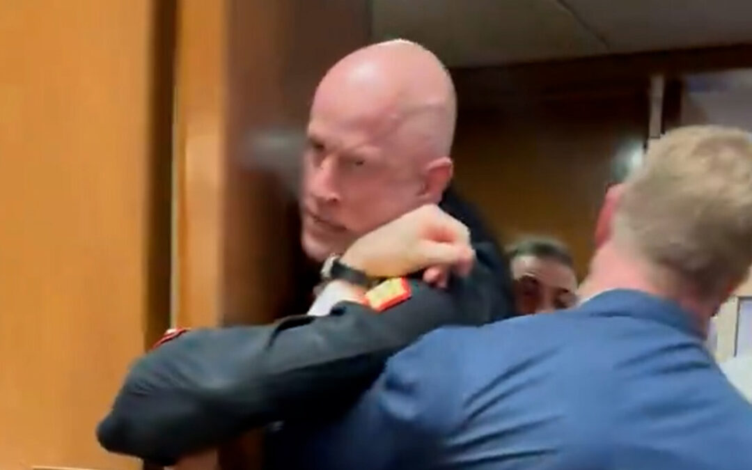 US Senator helps police drag anti-war protester from meeting