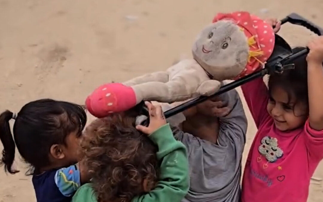 Children in Gaza reenact a funeral procession during play