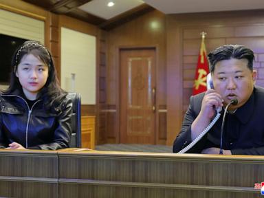 North Korean leader Kim and his daughter try out new pistols at shooting range