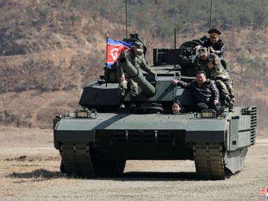 North Korean leader Kim and his daughter ride a tank together during army training