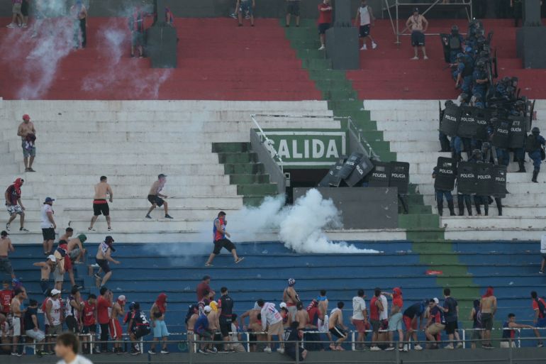 Several injured as fans clash with police in Paraguay’s Superclasico match
