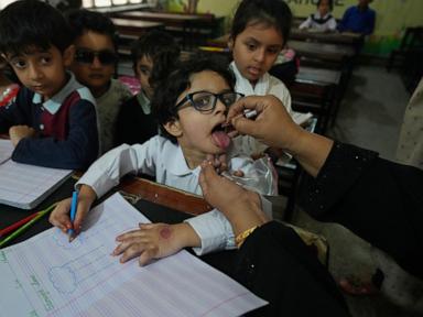 Suspected militants kill police officer assigned to guard polio team