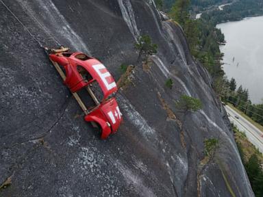 Car shell suspended on rock face above British Columbia highway in apparent prank