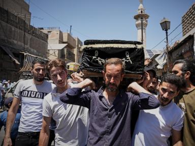 Mourners in Damascus bury cafe blast victims as officials promise justice
